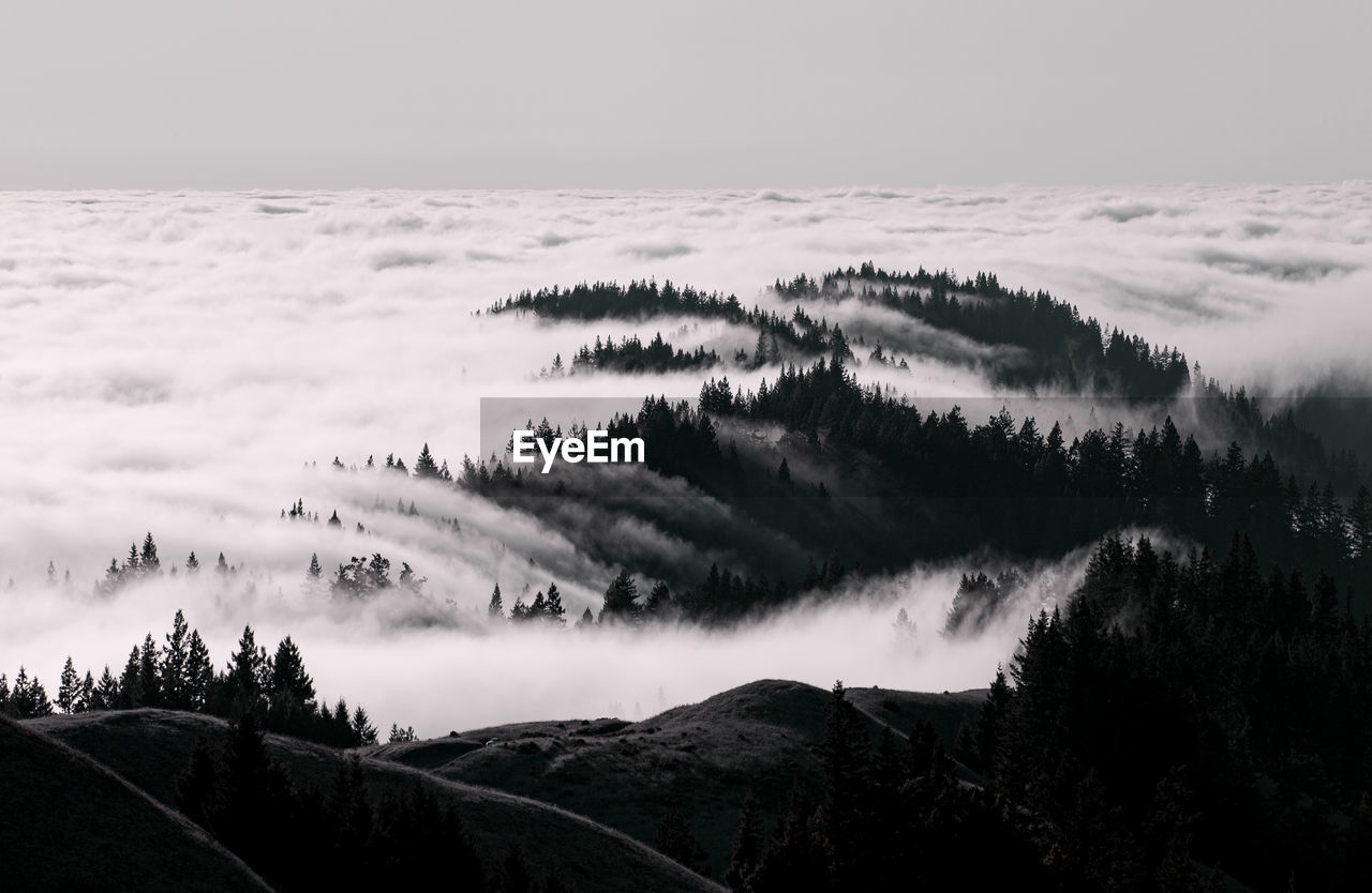 Panoramic view of fog and  mountains against sky
