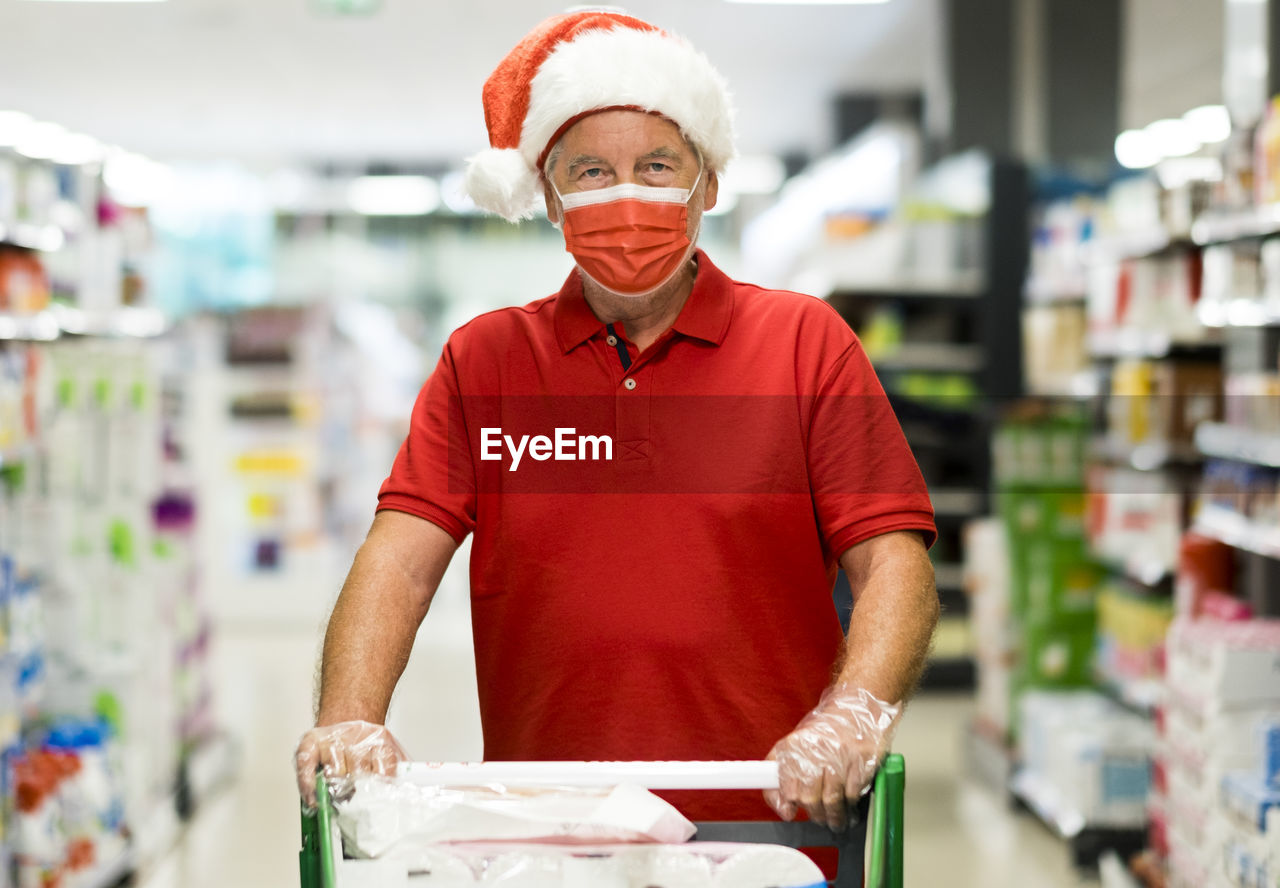 Portrait of smiling young man standing in store