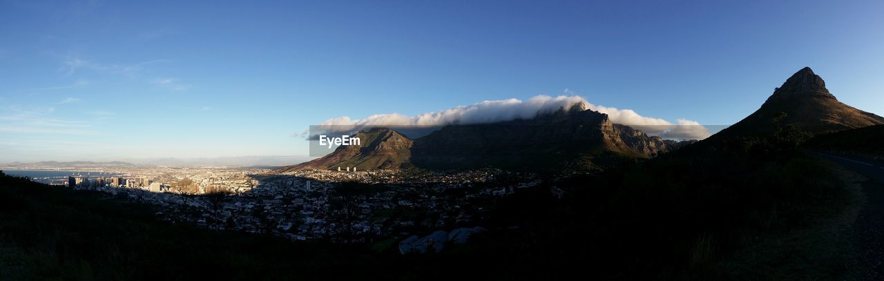 Scenic view of mountains against blue sky