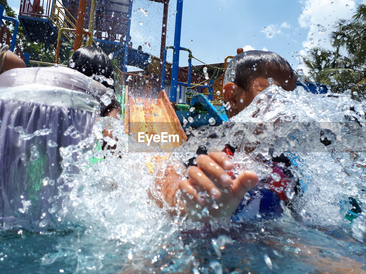 Boy splaying water at park