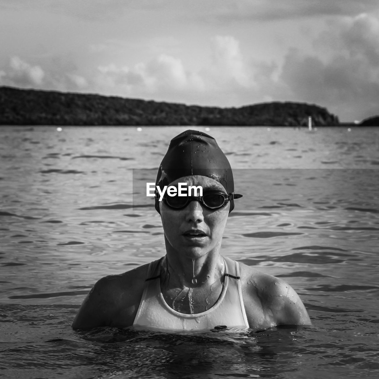 Portrait of woman swimming in sea against sky