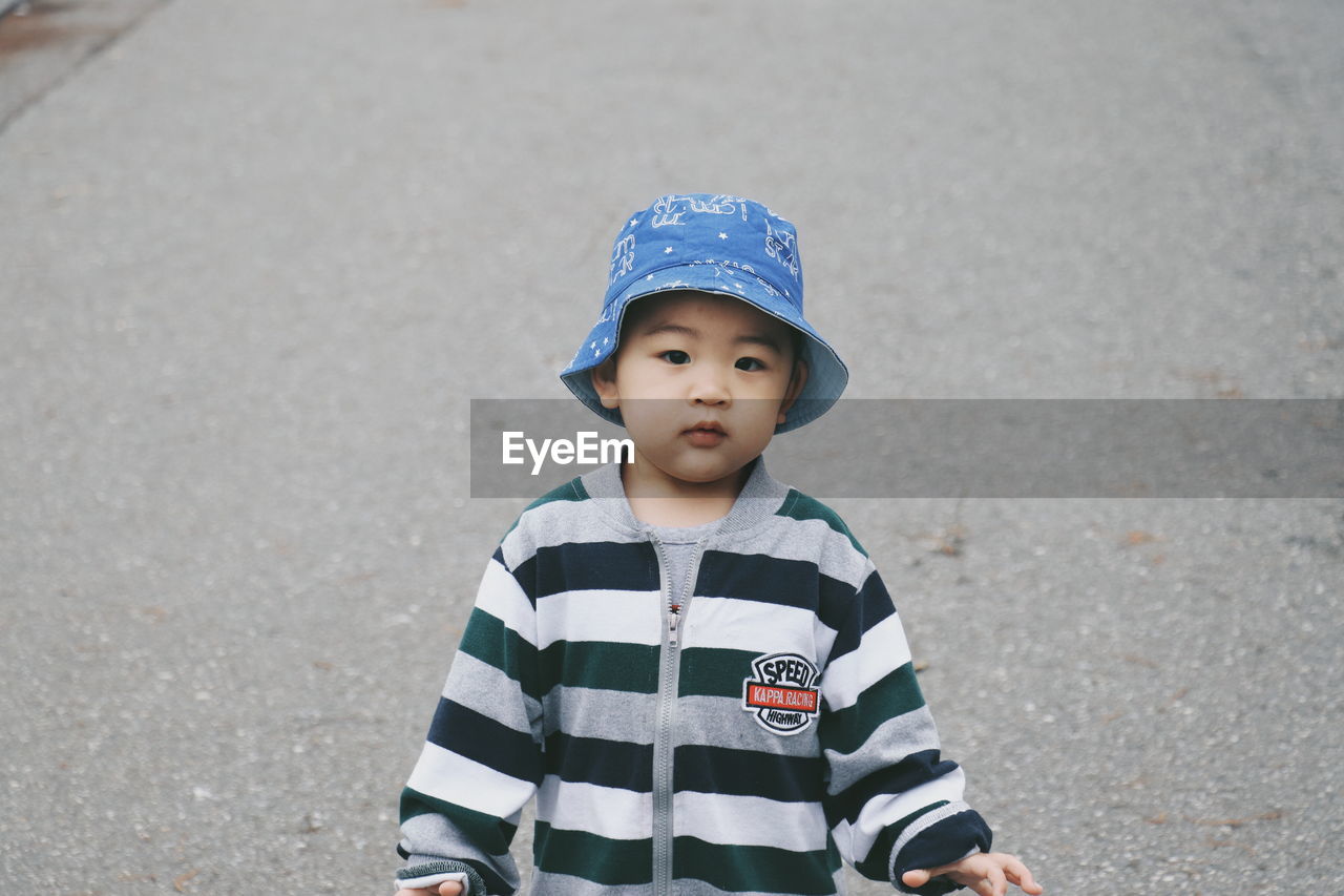 Portrait of cute boy standing outdoors