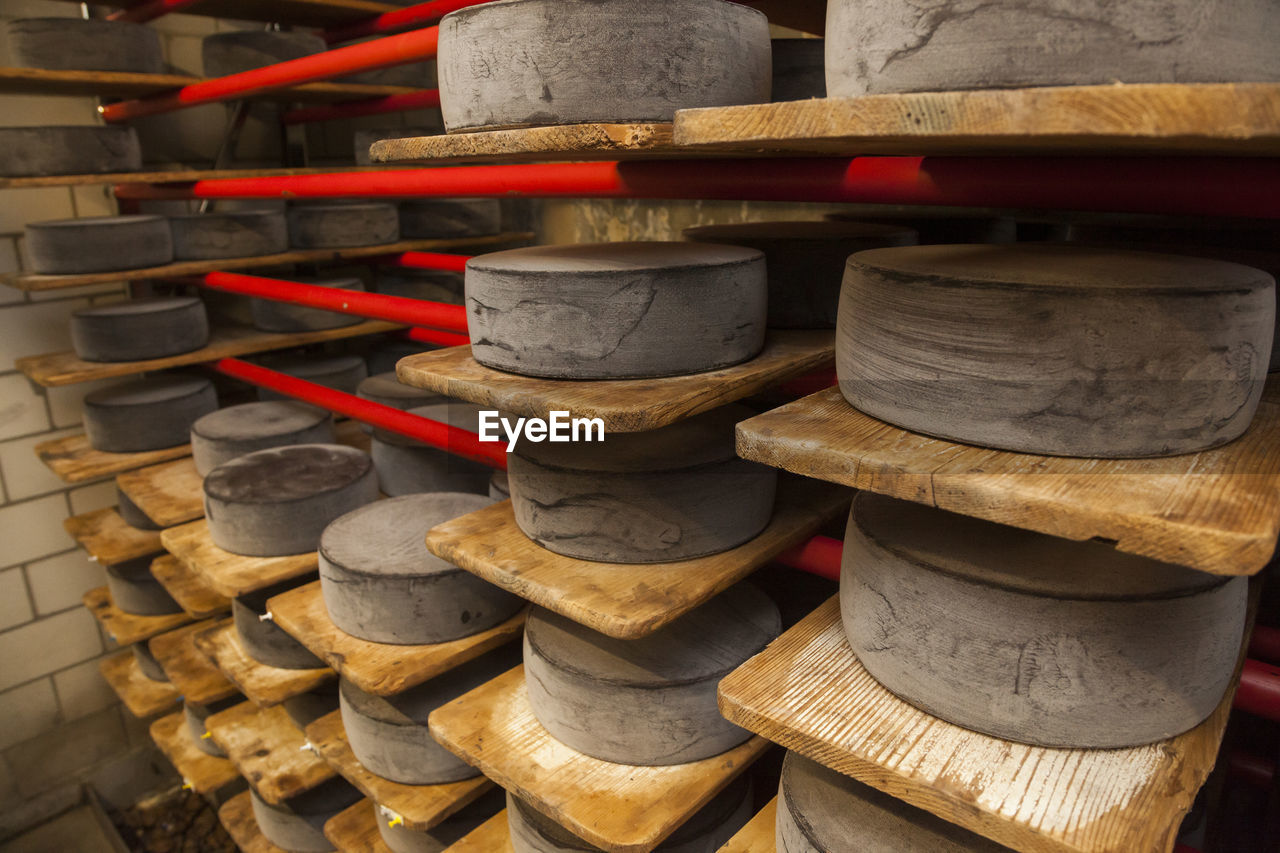 Wheels of raw cow milk cheese age at creamery in hinwil, switzerland