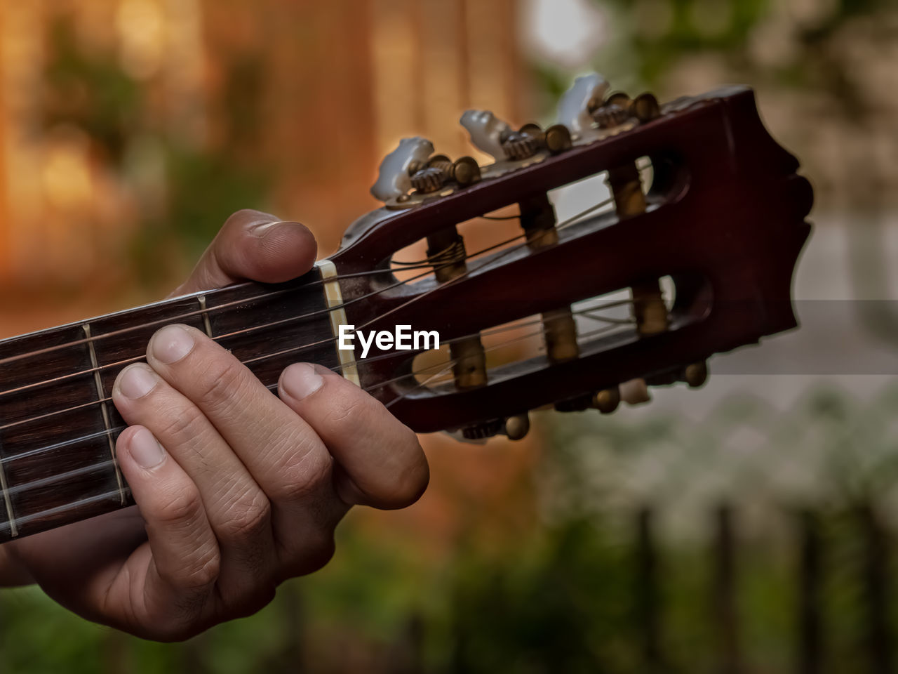 Cropped hand of person playing guitar