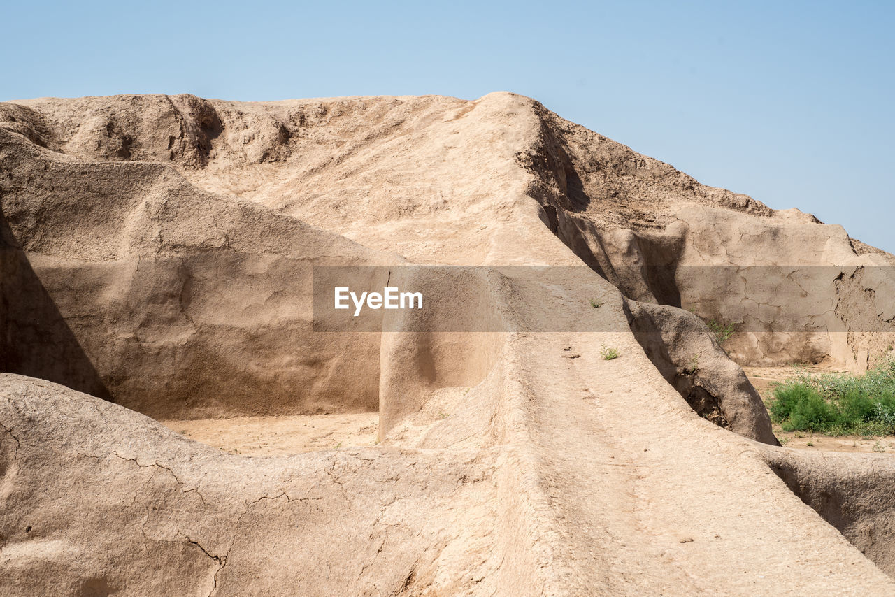 LOW ANGLE VIEW OF ROCKS AGAINST CLEAR SKY