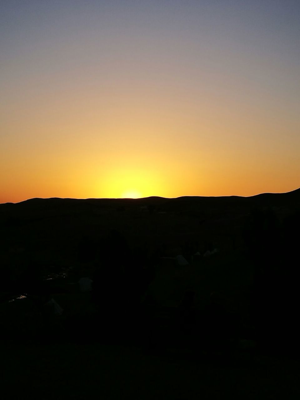 SILHOUETTE LANDSCAPE AGAINST ORANGE SKY