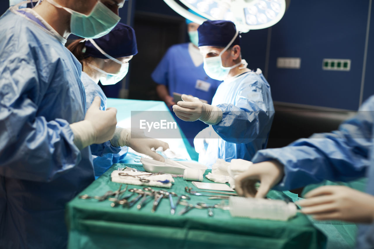 Doctors operating patient in emergency room