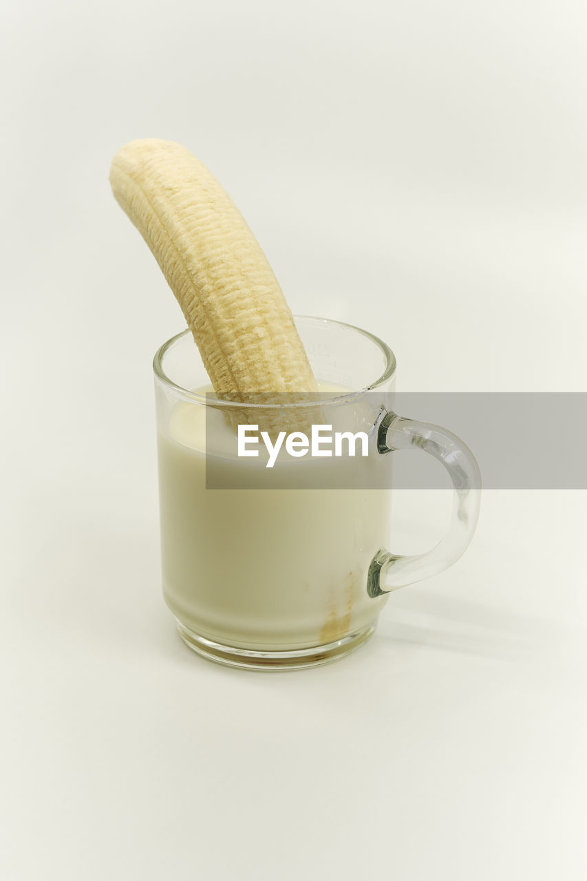 Close-up of milk glass against white background