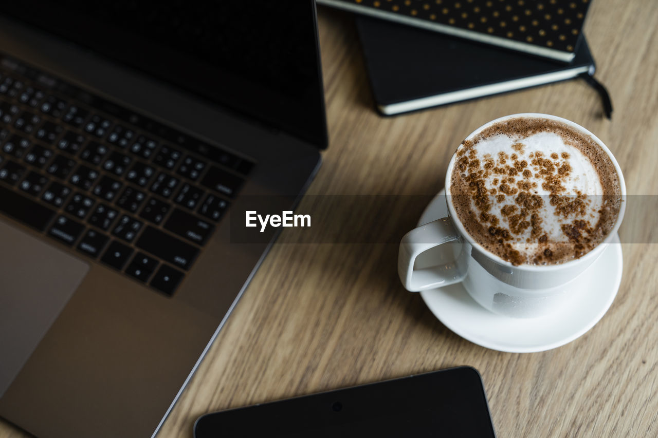 HIGH ANGLE VIEW OF COFFEE CUP AND TABLE