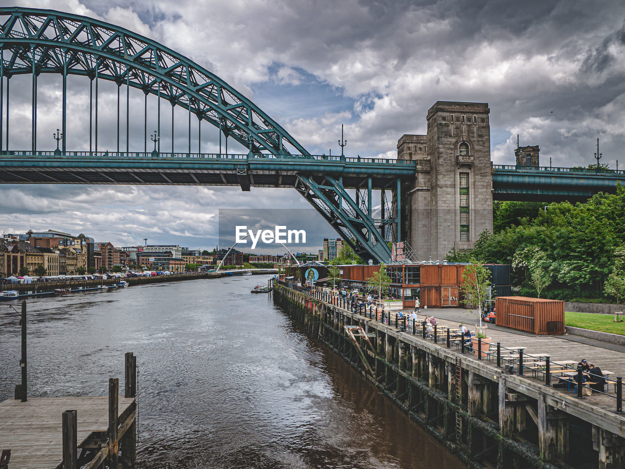 Bridge over river against cloudy sky