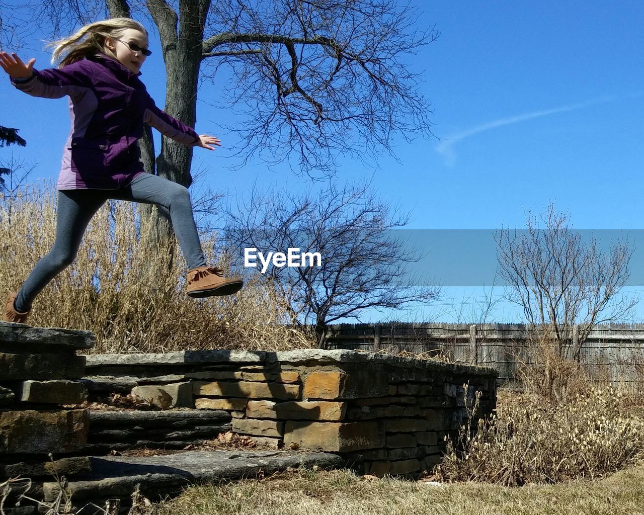 Girl jumping while running in park