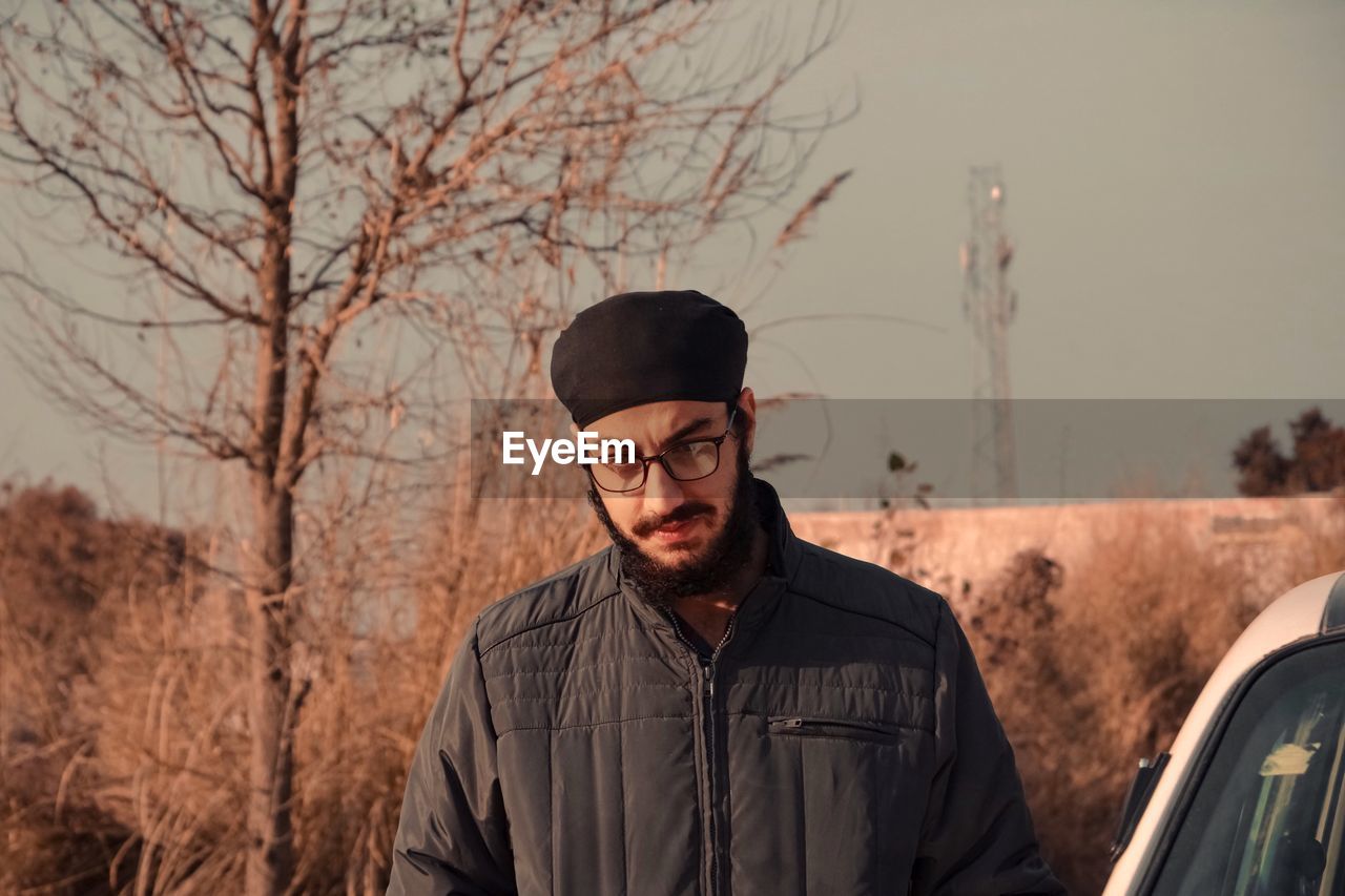 Young man wearing eyeglasses standing outdoors