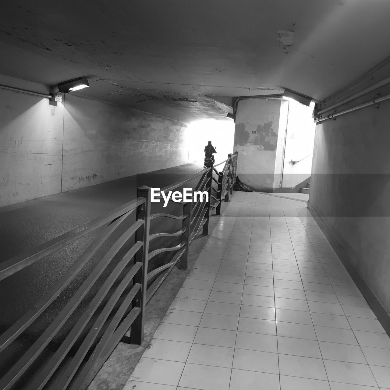 Man riding motorcycle in illuminated tunnel