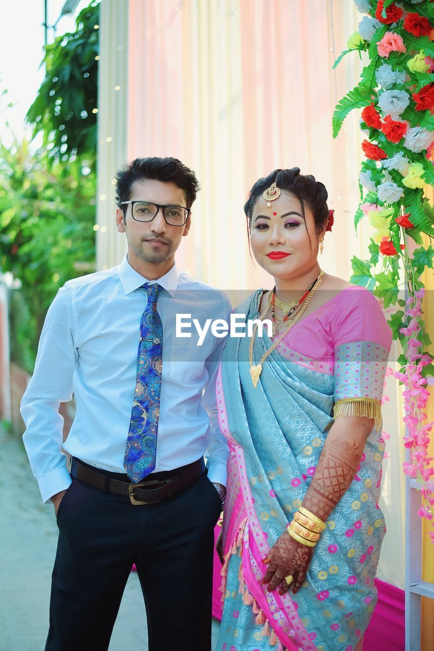 Portrait of smiling couple standing against sky