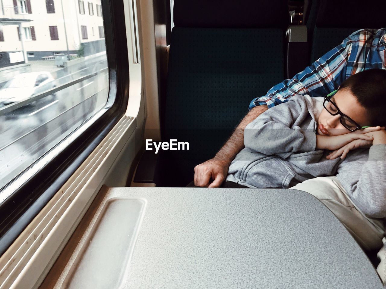 Close-up of boy sleeping on train