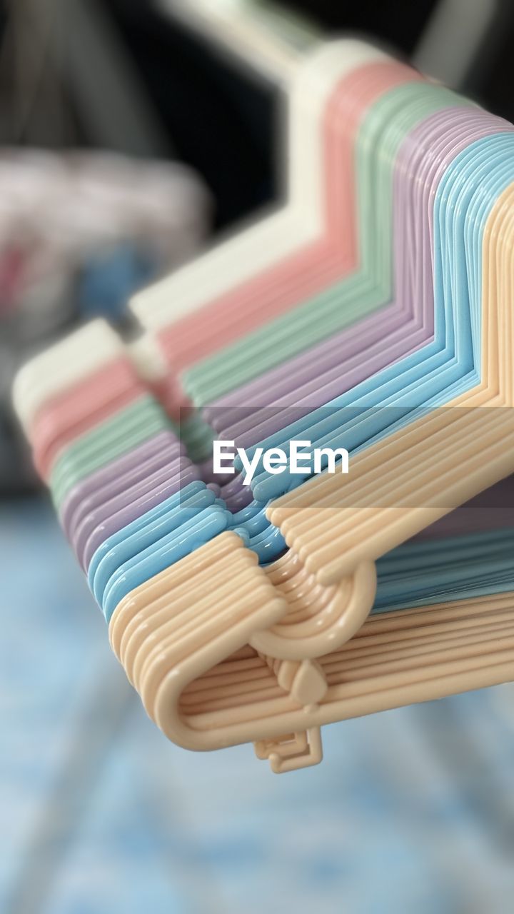 close-up, focus on foreground, multi colored, no people, indoors, blue, business, selective focus, large group of objects, variation