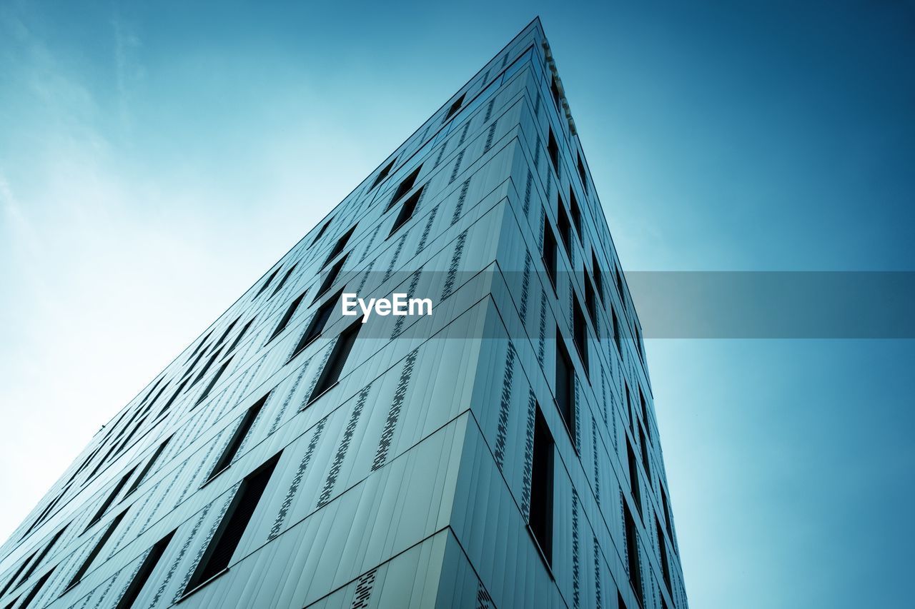 Low angle view of modern building against clear blue sky