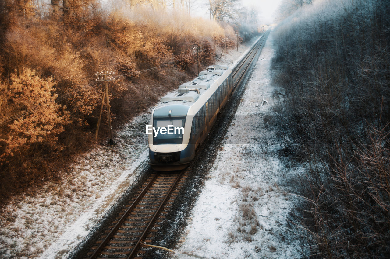 Train passing through railroad track during winter 