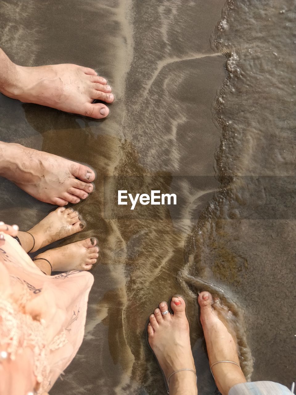 LOW SECTION OF PEOPLE STANDING IN WATER AT PARK