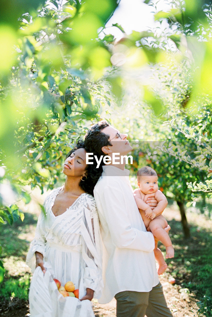 Couple with daughter standing at farm