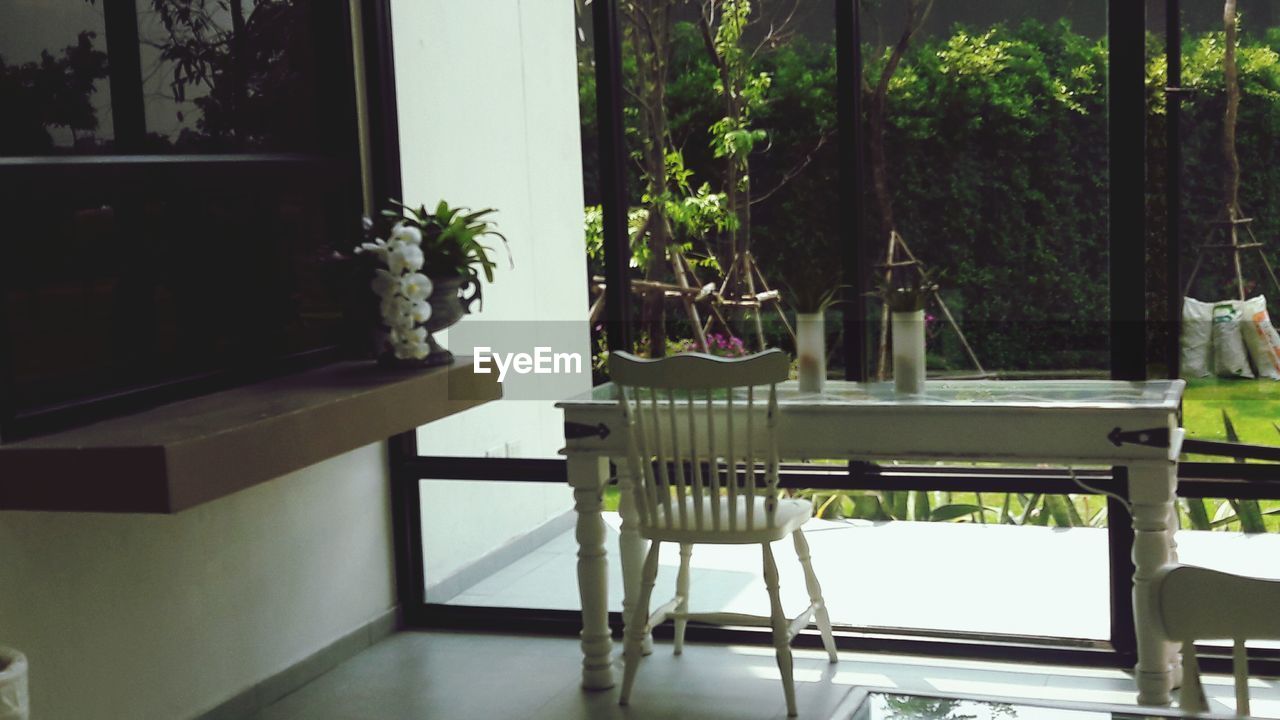 TABLE AND CHAIRS AGAINST THE WINDOW