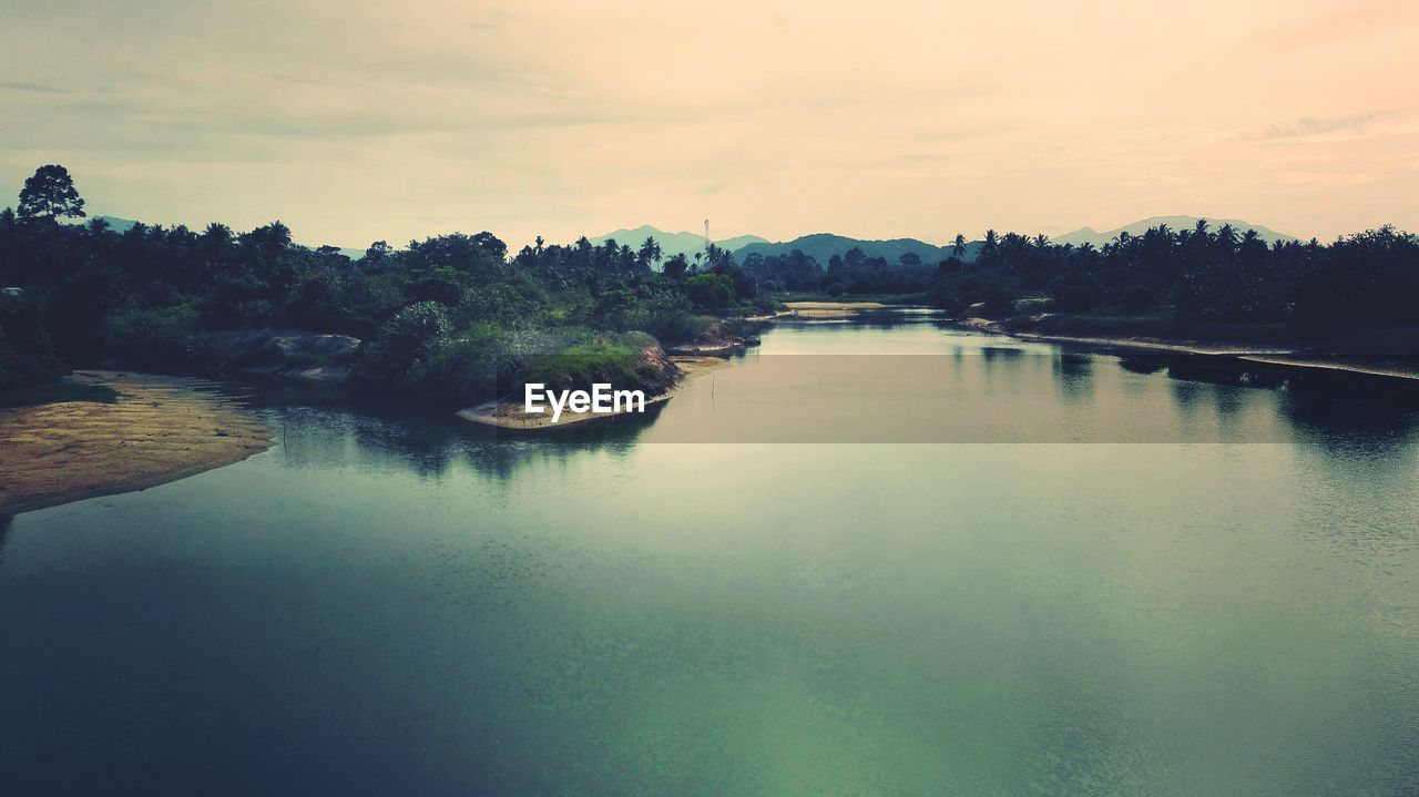 Scenic view of lake against sky during sunset