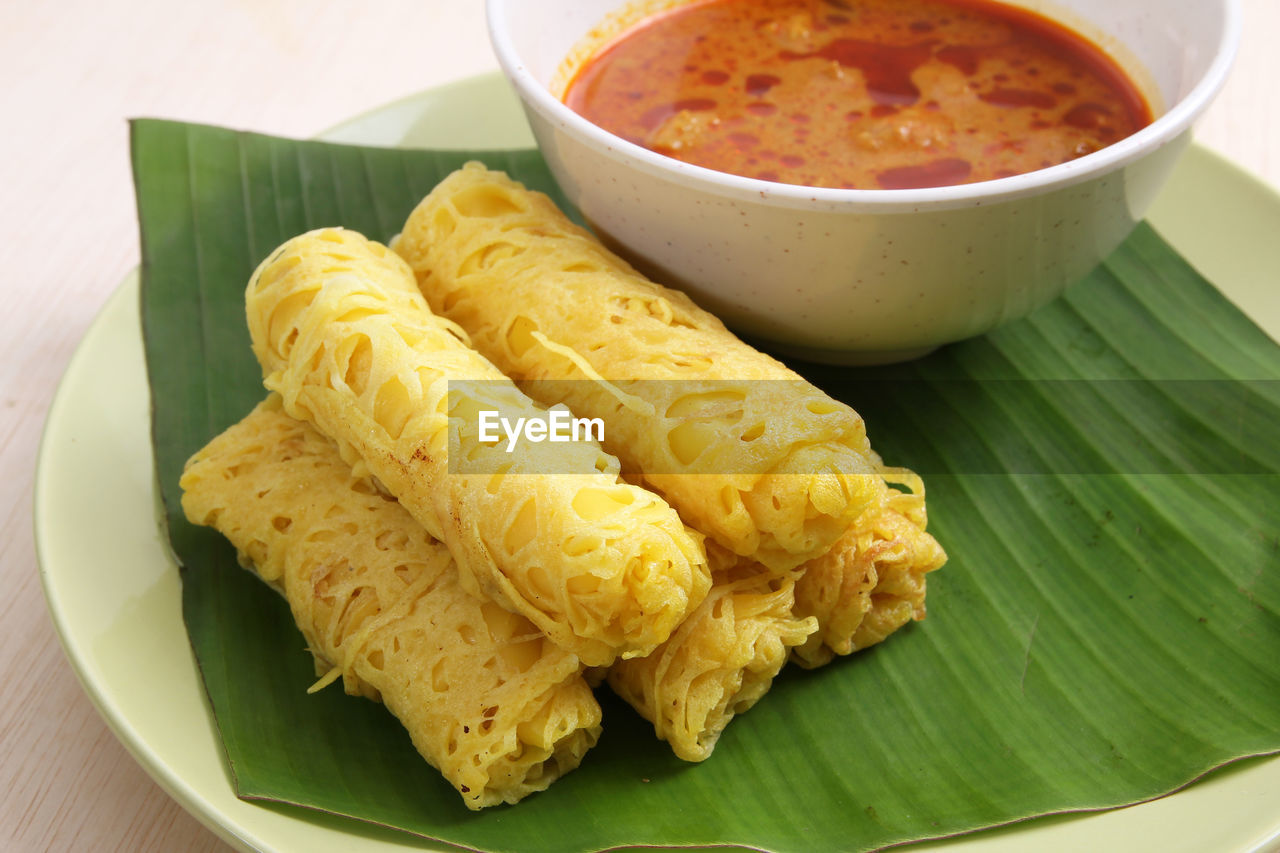 Close-up of roti jala in plate on table