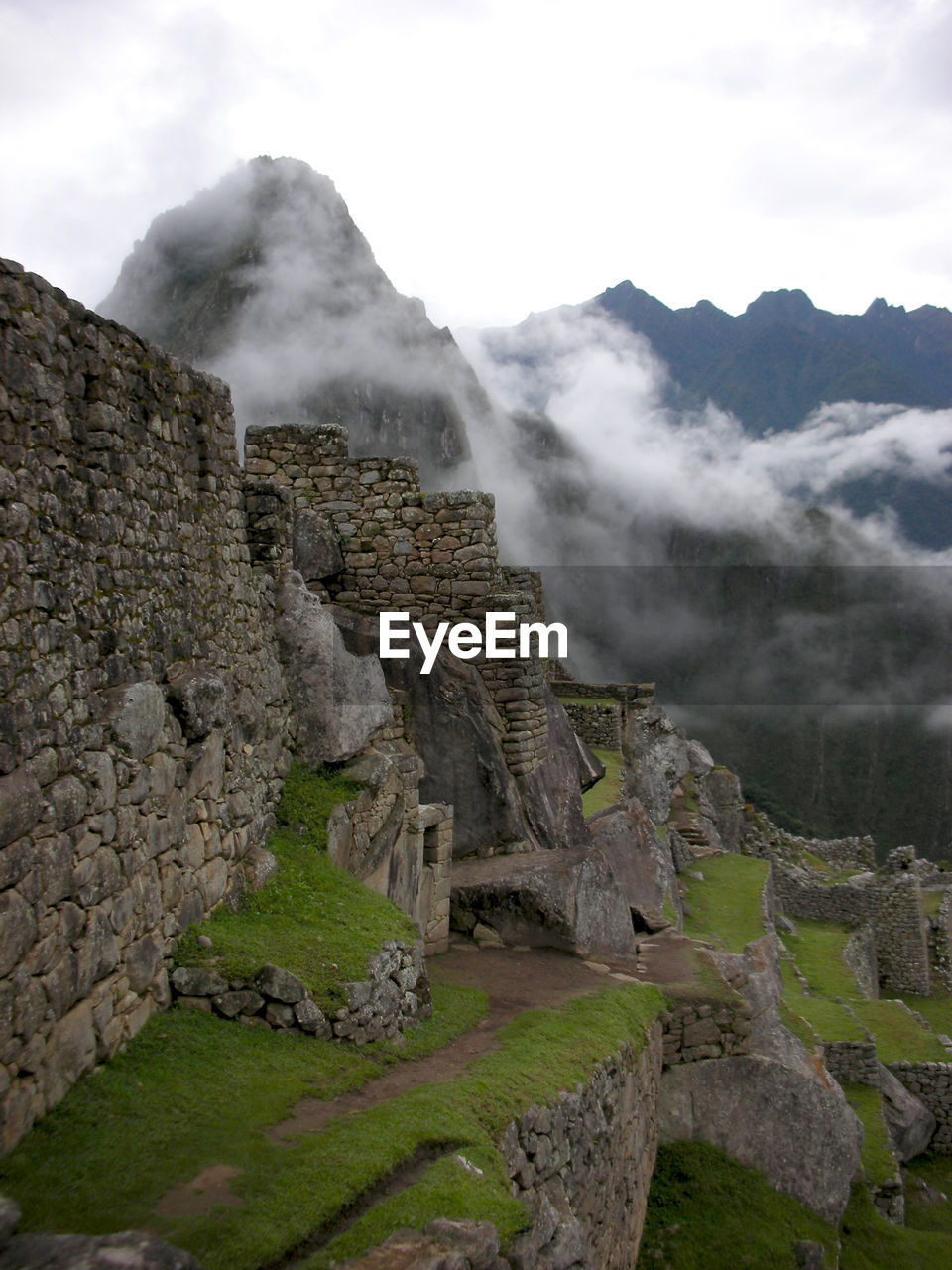 Scenic view of machu picchu side walls with clouds