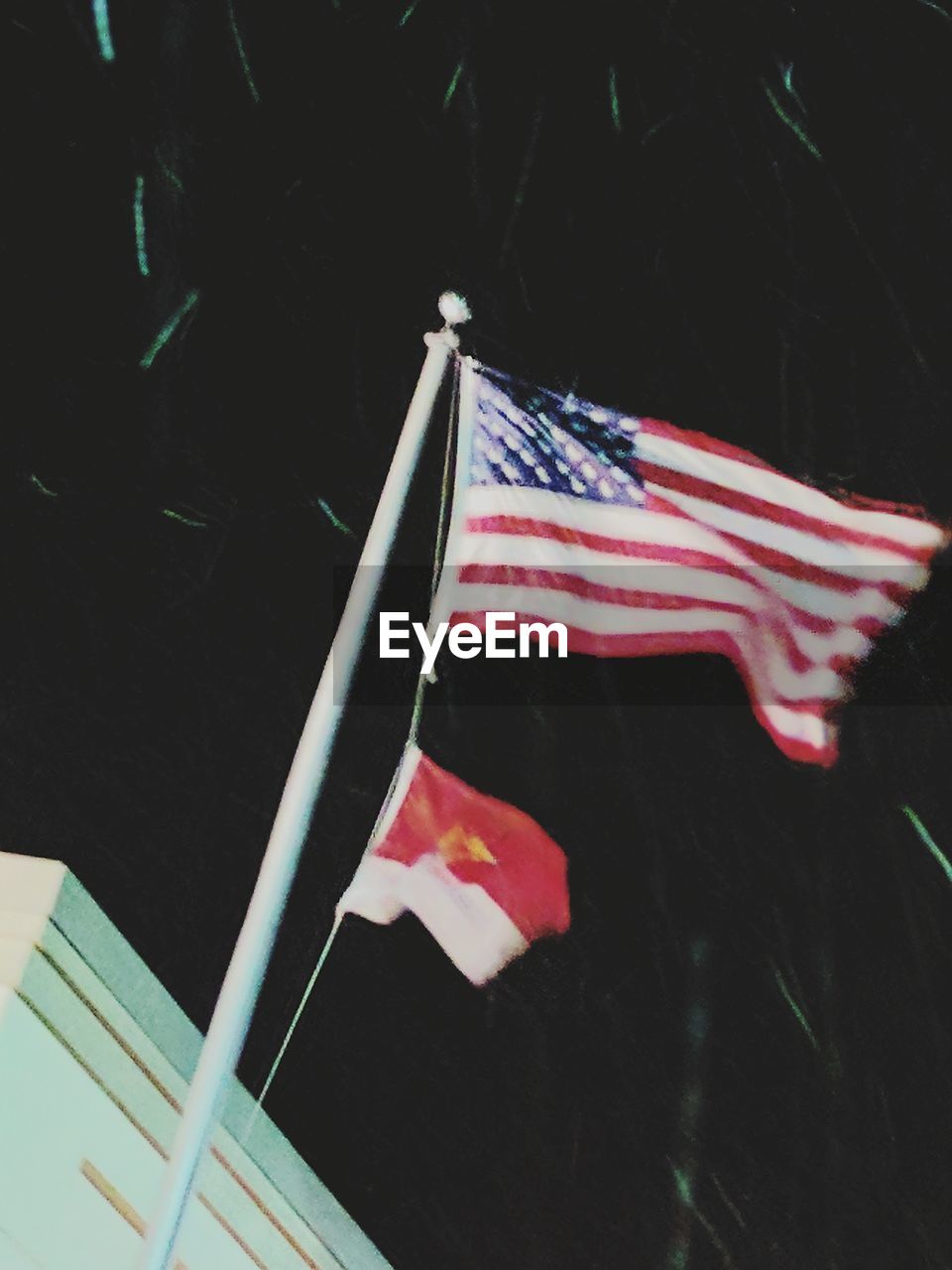 LOW ANGLE VIEW OF FLAGS AGAINST THE SKY