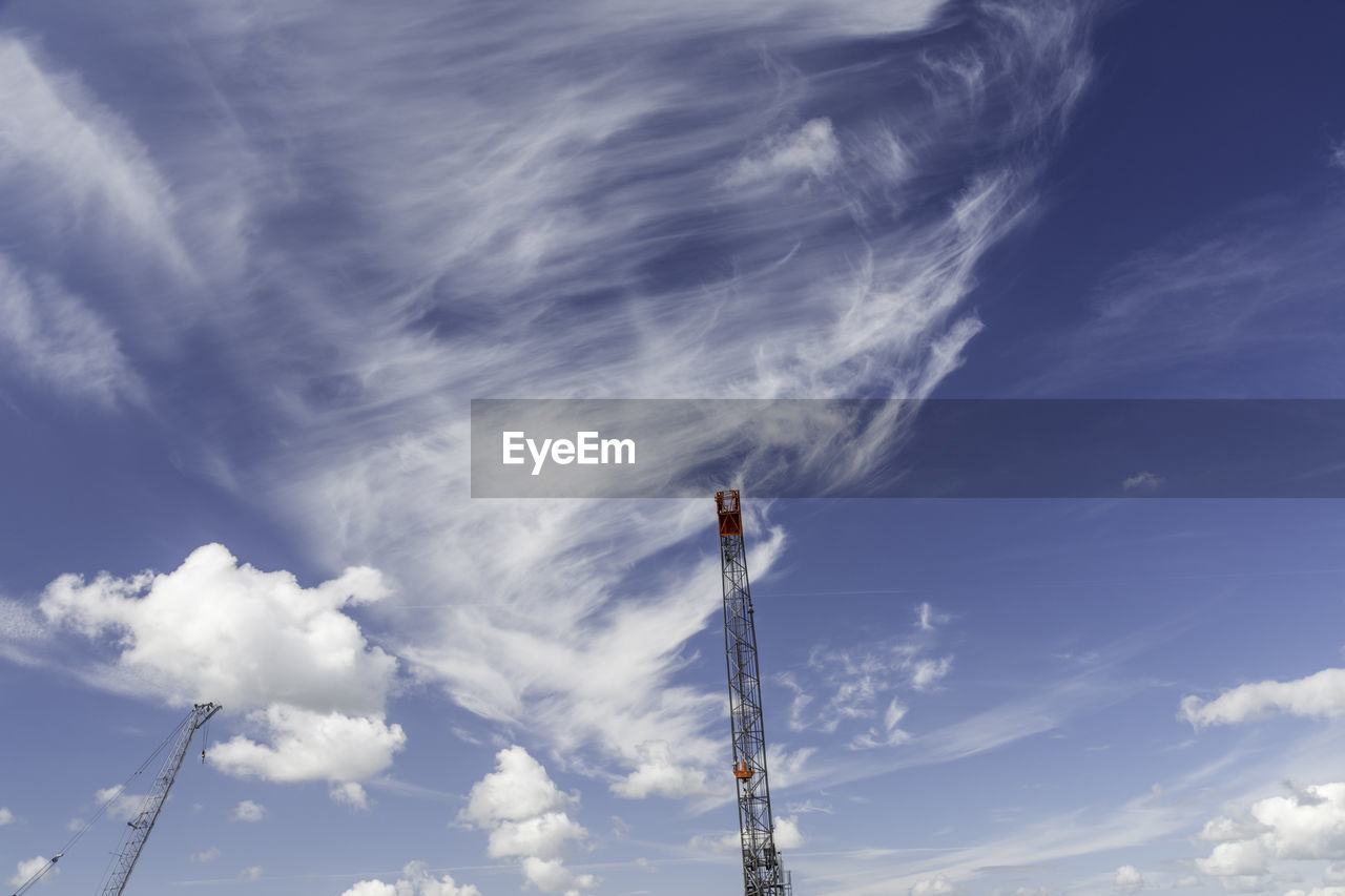 Low angle view of communications tower against sky