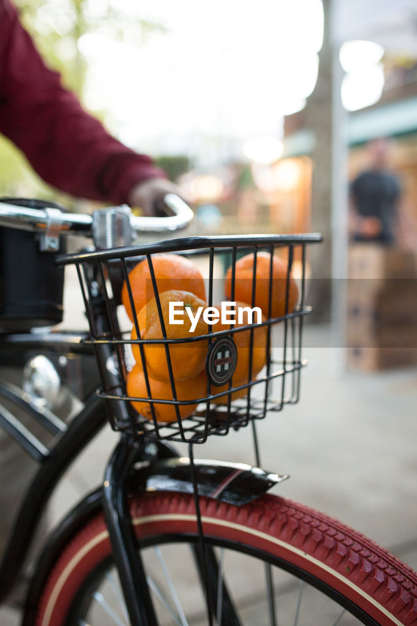 Close-up of fresh oranges in basket on bicycle