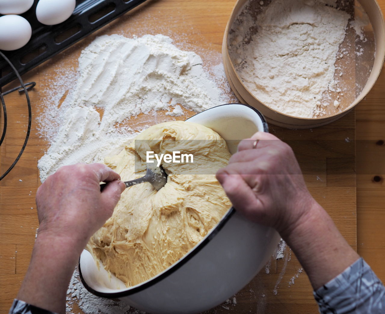 The woman's hands roll out the dough.a woman's hobby.food background.