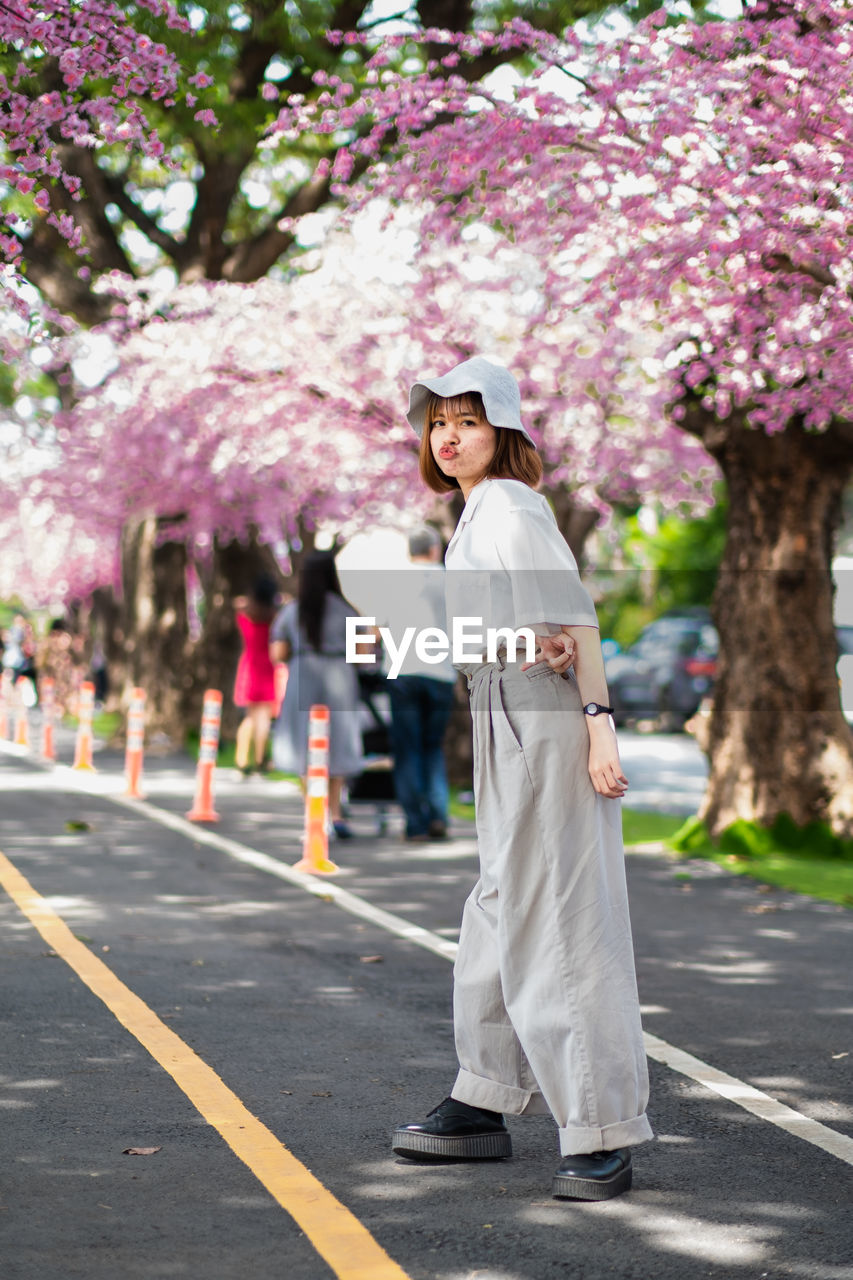 Full length of woman standing on road