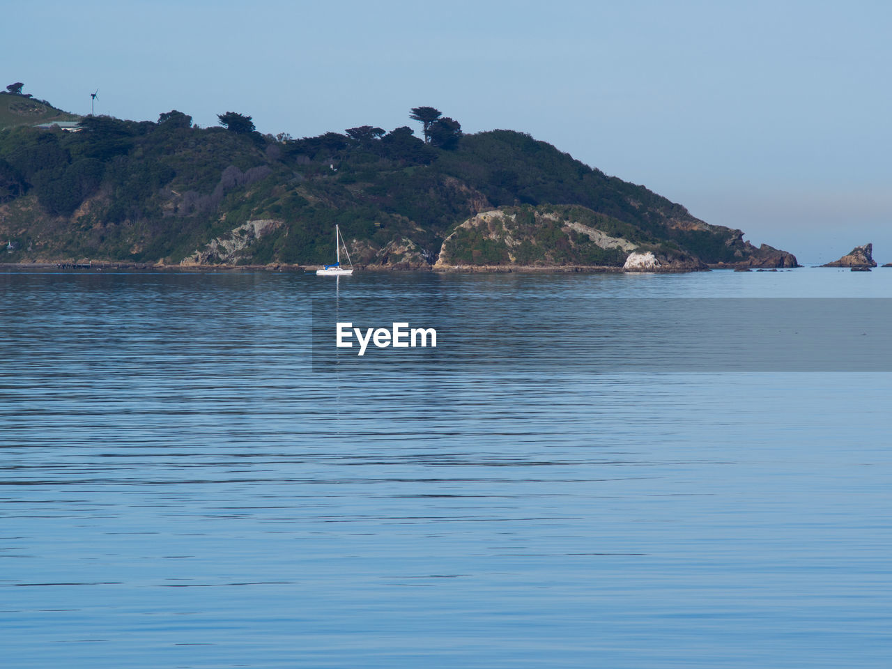 SCENIC VIEW OF SEA WITH MOUNTAINS IN BACKGROUND