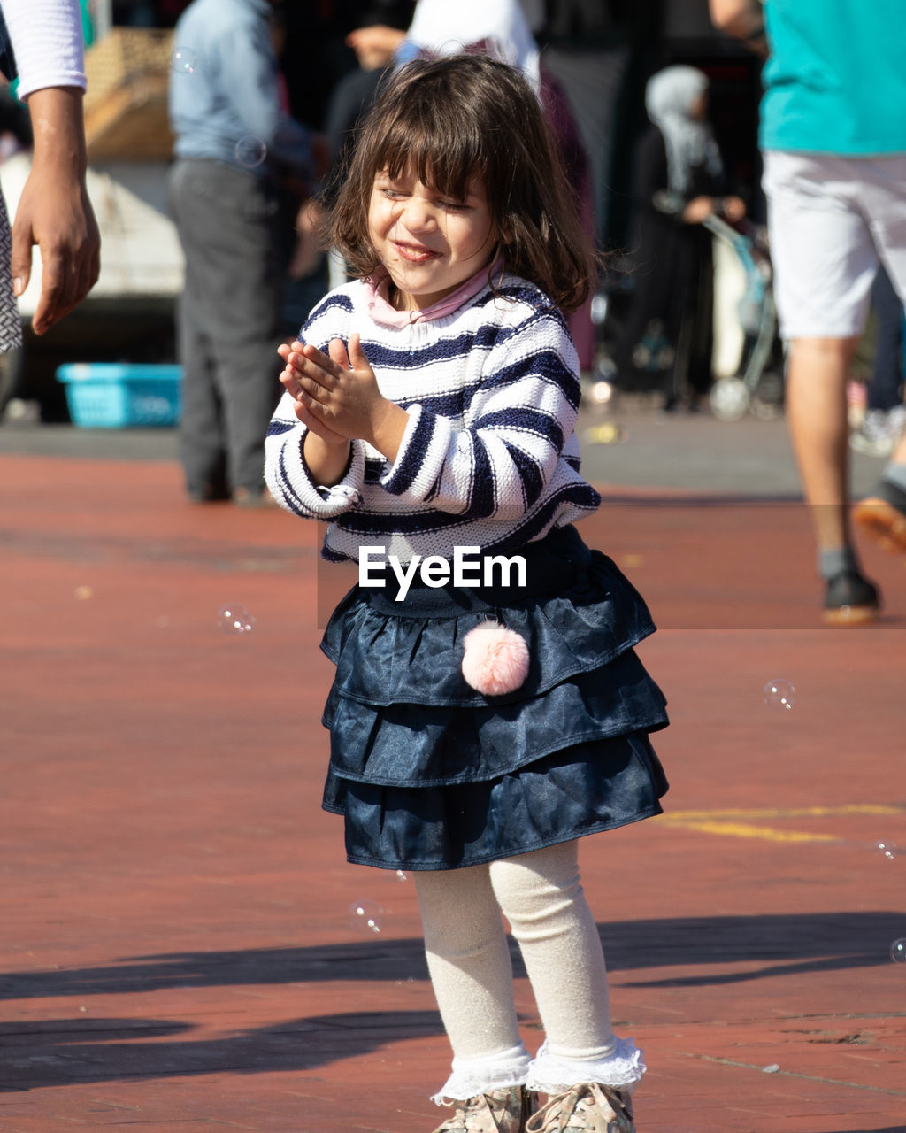 Smiling girl standing outdoors