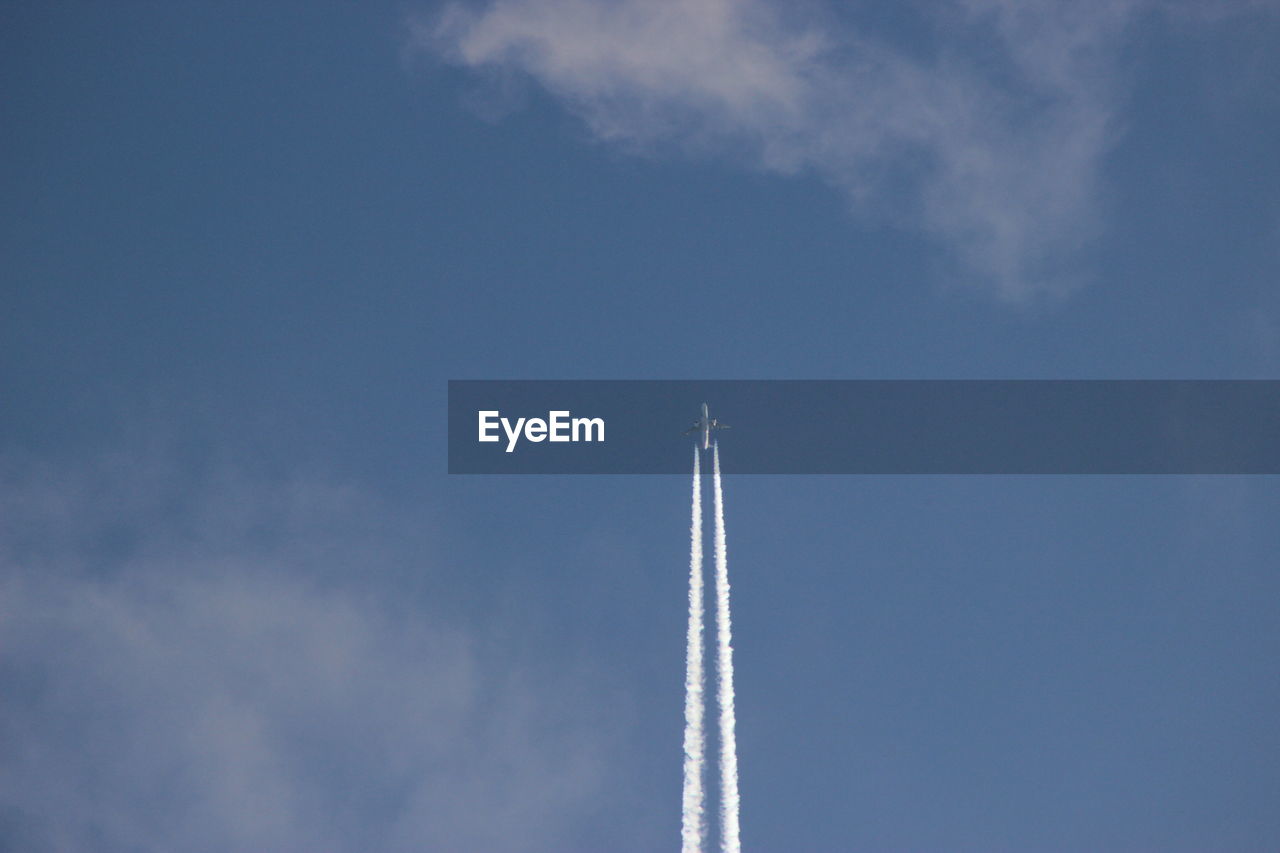 LOW ANGLE VIEW OF VAPOR TRAILS IN SKY