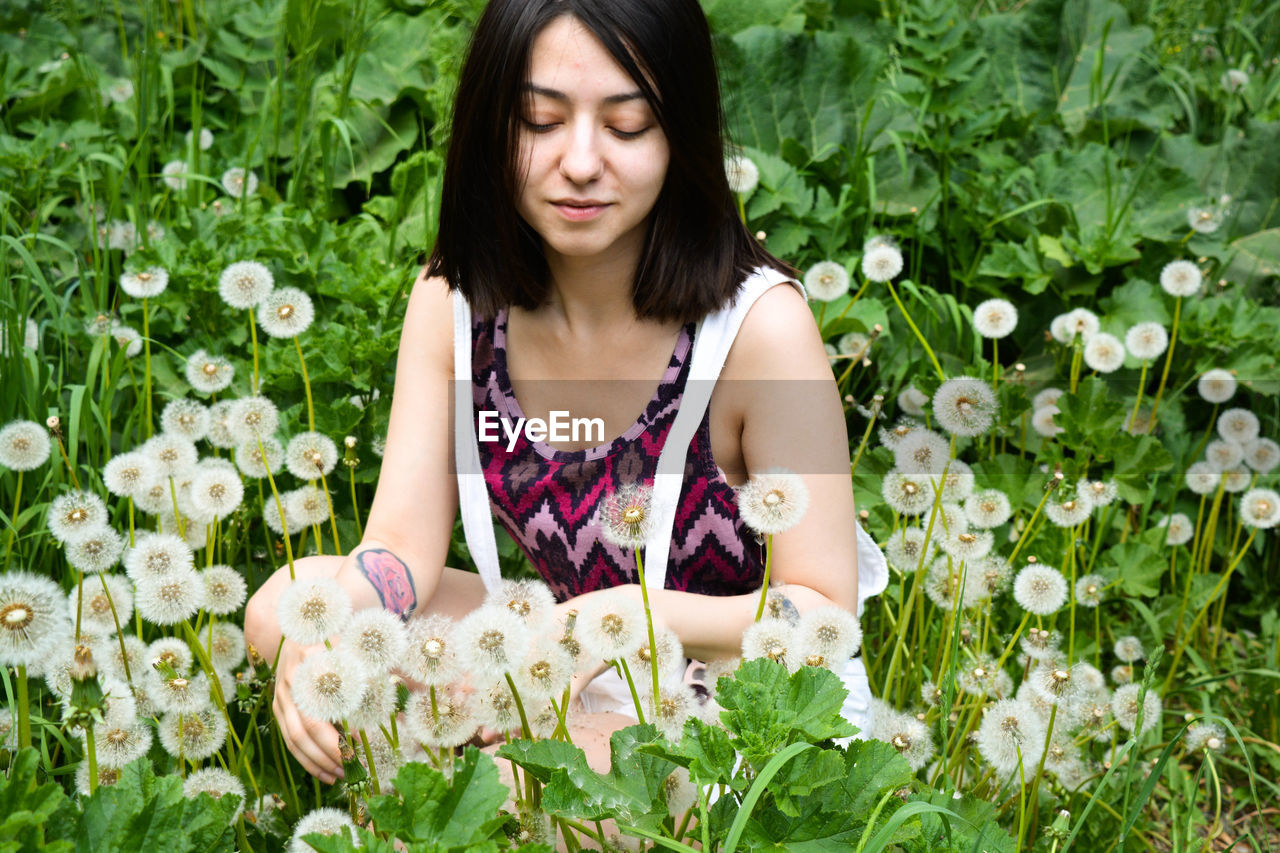 Beautiful woman by flowering plants