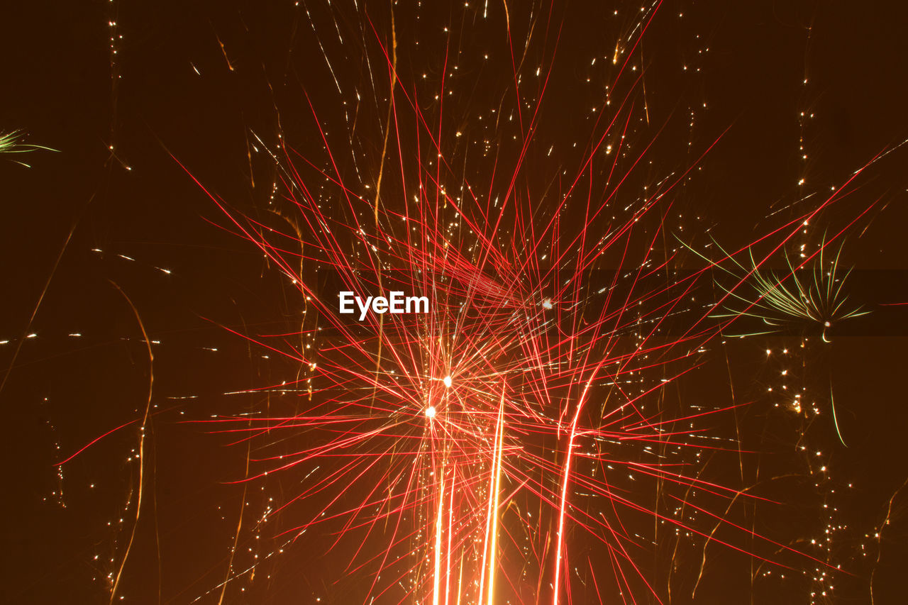 Low angle view of firework display at night