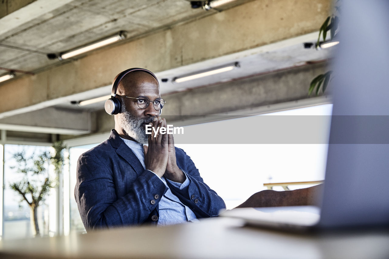 Businessman concentrating while working on laptop at home