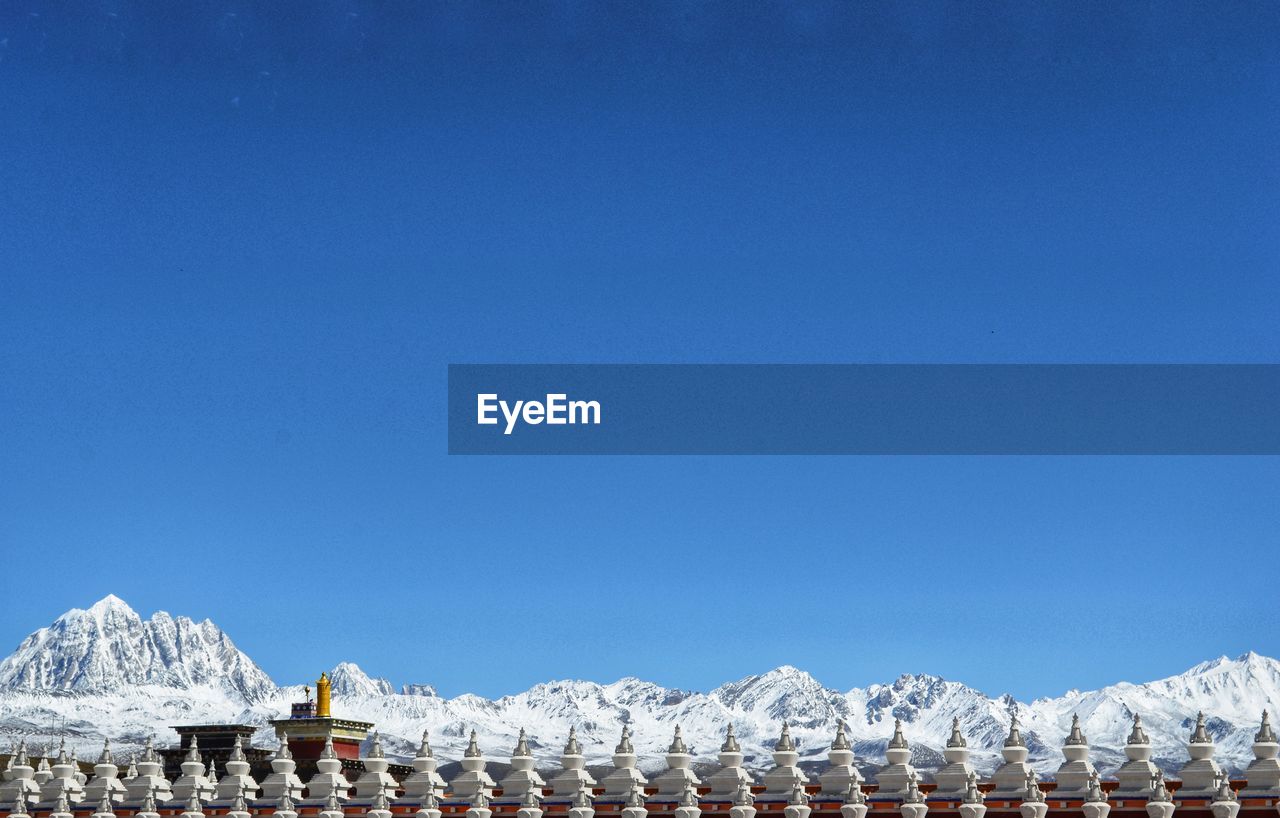 Panoramic view of buildings against blue sky