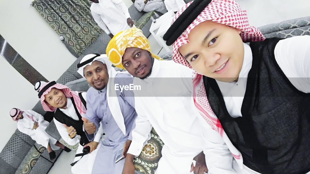 PORTRAIT OF YOUNG COUPLE STANDING AGAINST MODERN