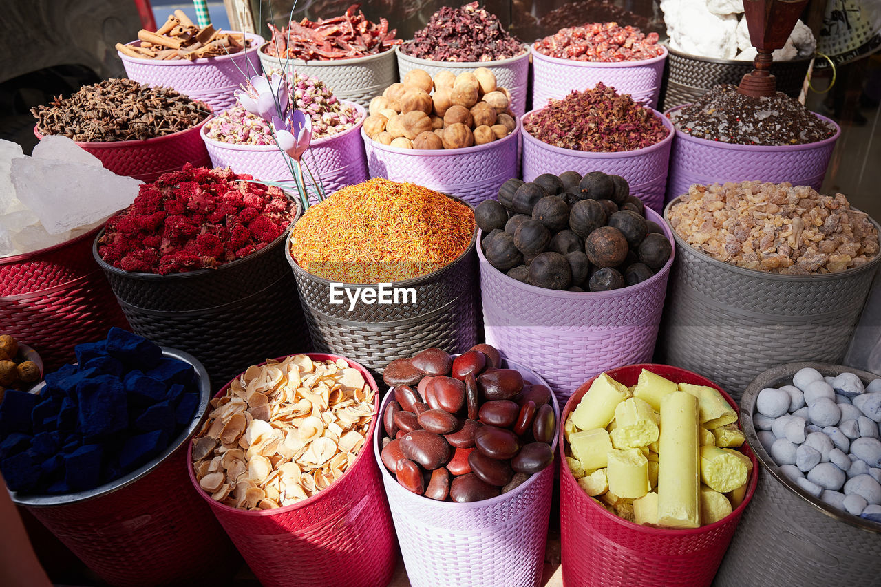 Colorful boxes with dried spices, tea and incense at bazaar market in dubai