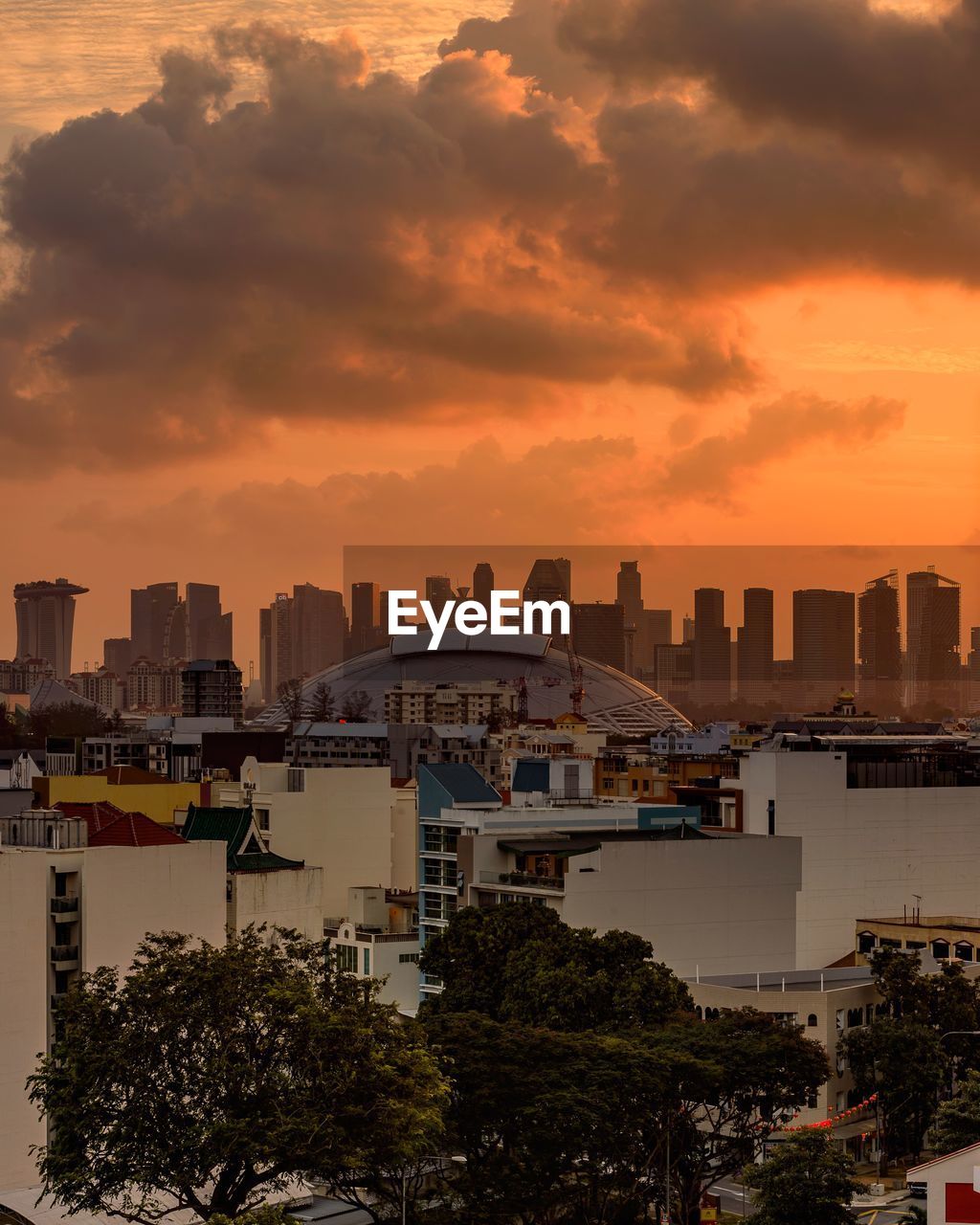 View of cityscape against cloudy sky during sunset