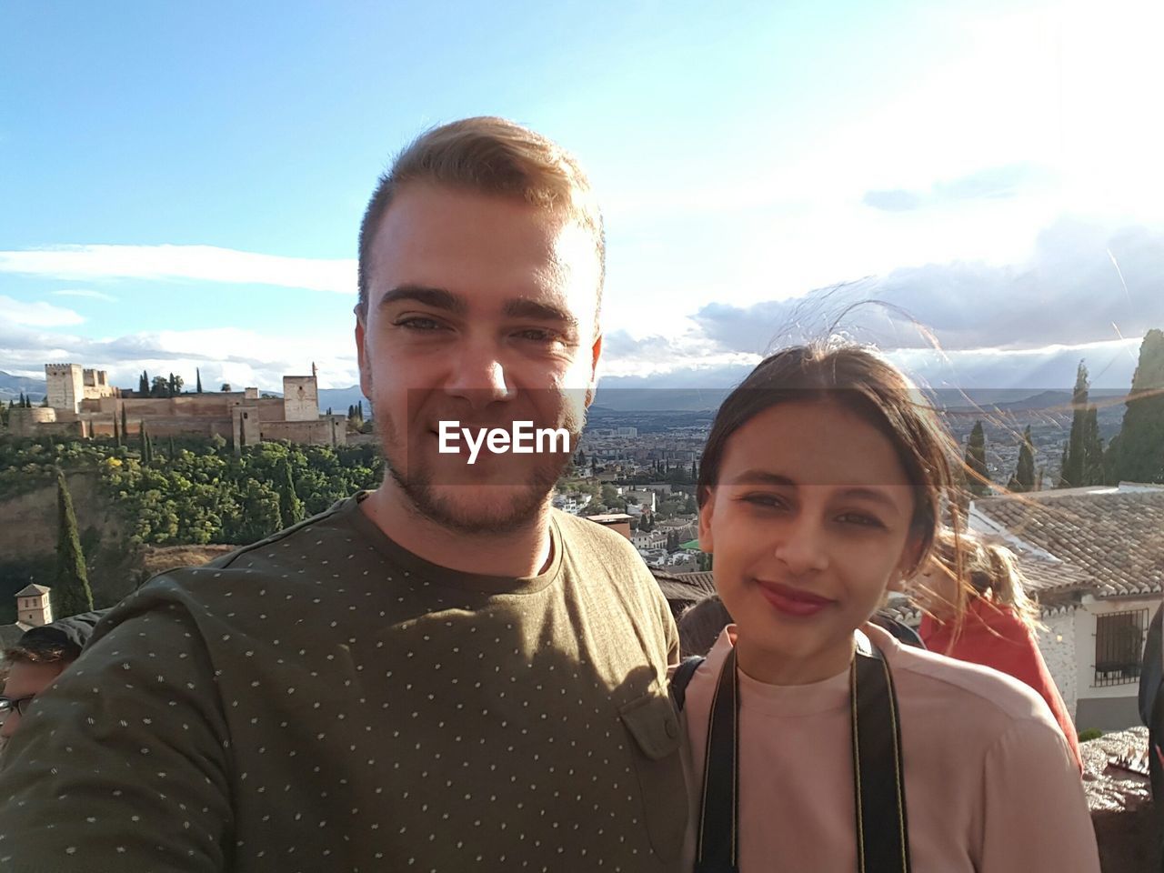 Portrait of smiling friends against cityscape