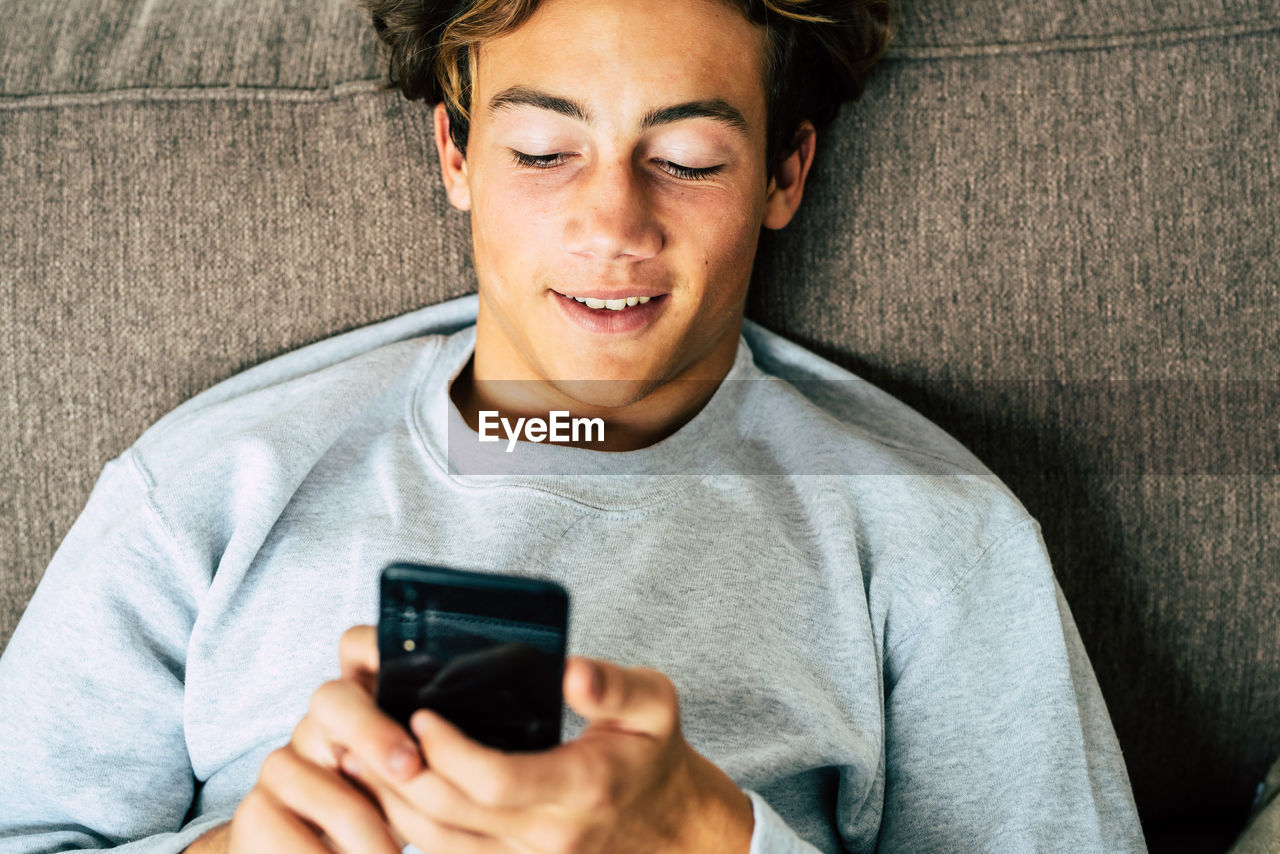 Close-up of teenage boy using mobile phone