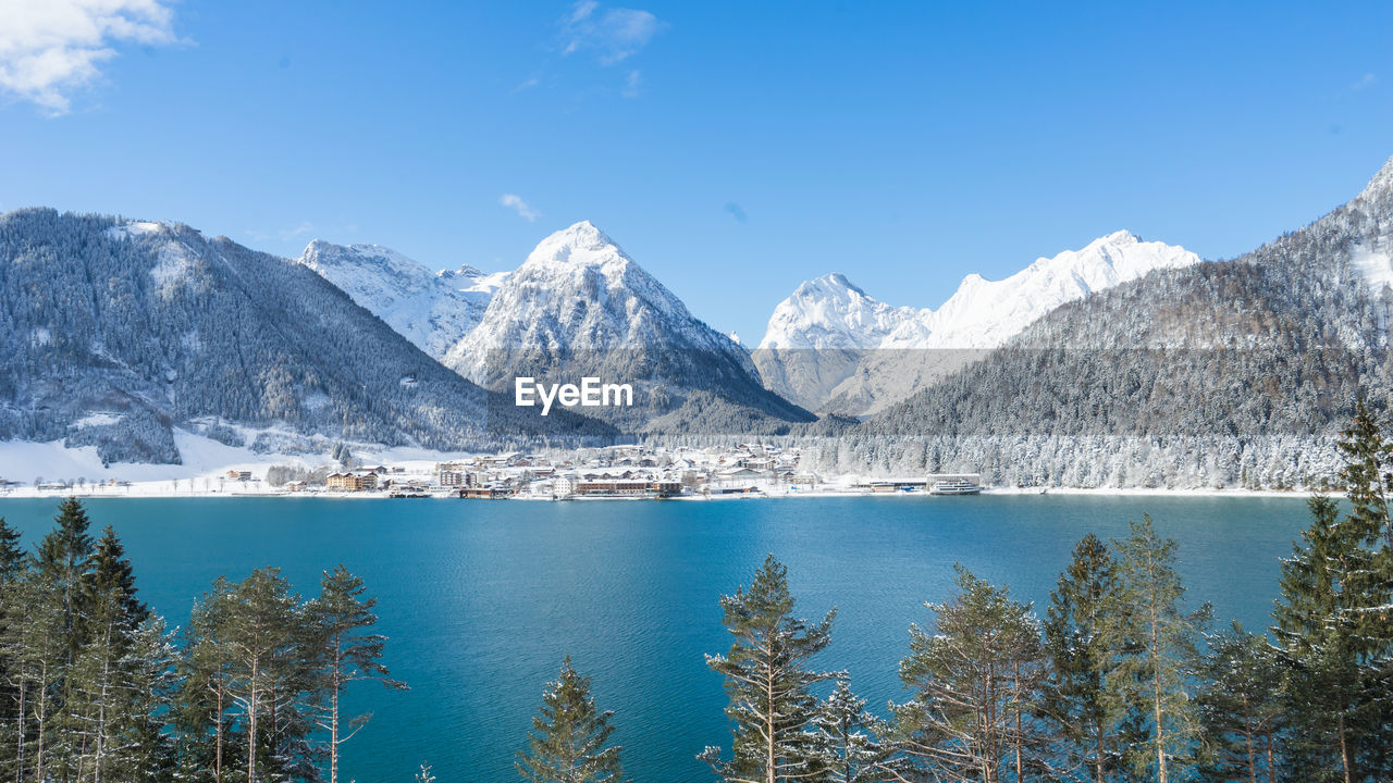 Scenic view of lake and snowcapped mountains against sky