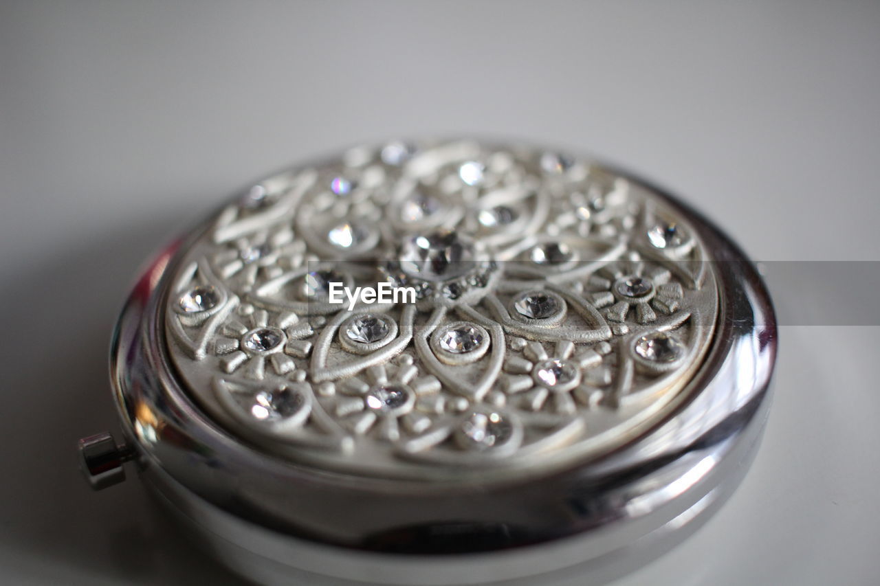 Close-up of patterned container on table