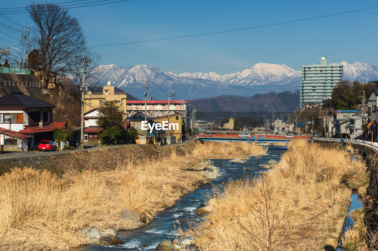 Shibu onsen city and central alps mount against blue sky, yamanouchi, nagano, japan. 