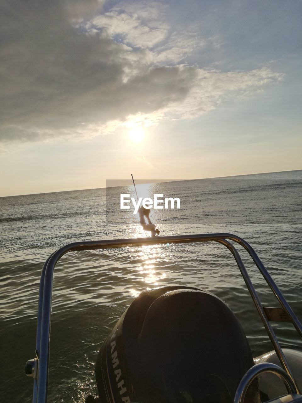 MAN ON SEA AGAINST SKY