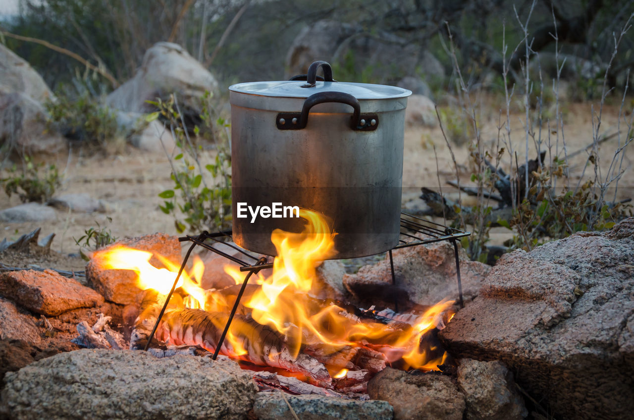 Close-up of saucepan on bonfire in african bush